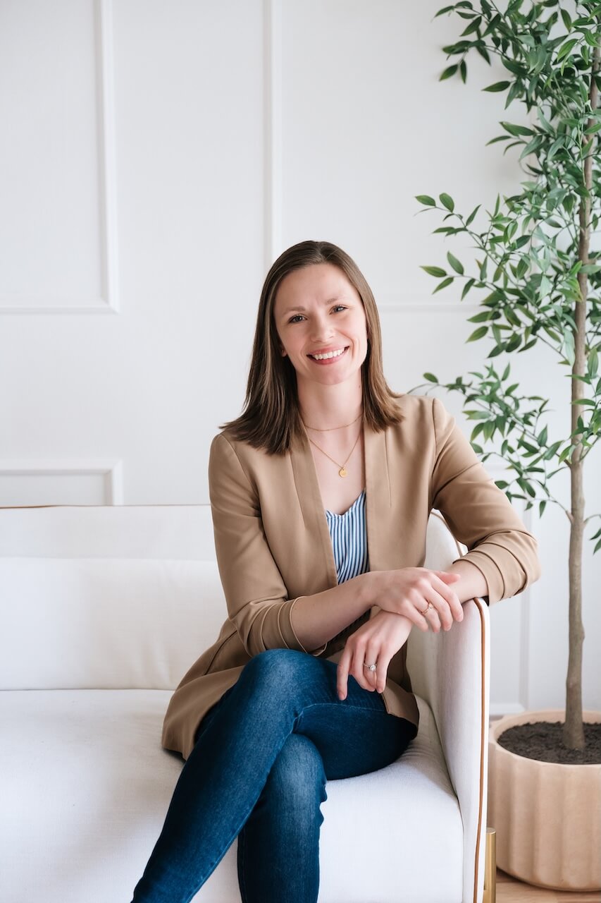 Smiling woman seated on a white sofa