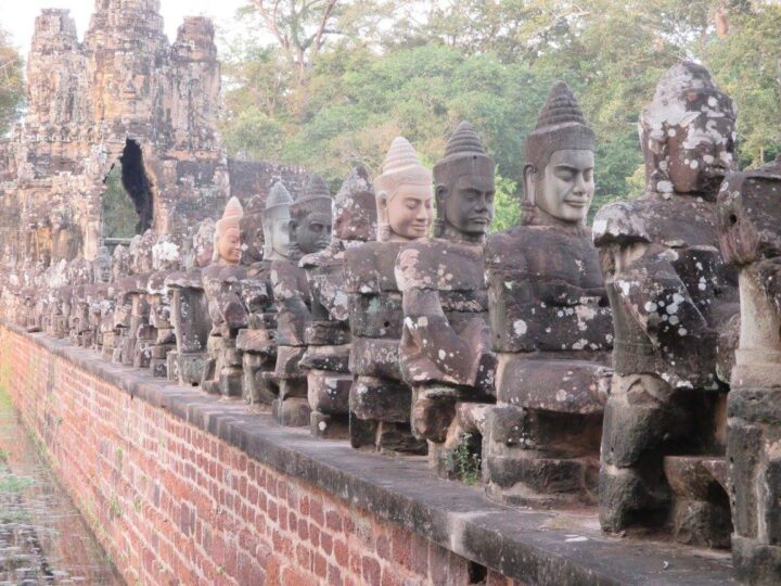 Ancient stone statues at Angkor Thom entrance.