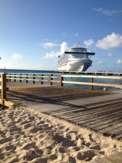 Cruise ship docked at sandy shore