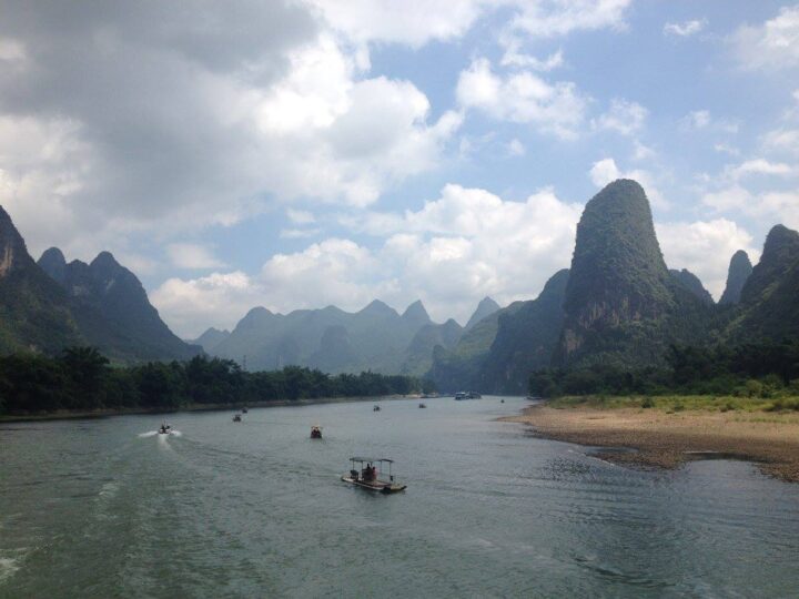Boats on river with karst mountains.