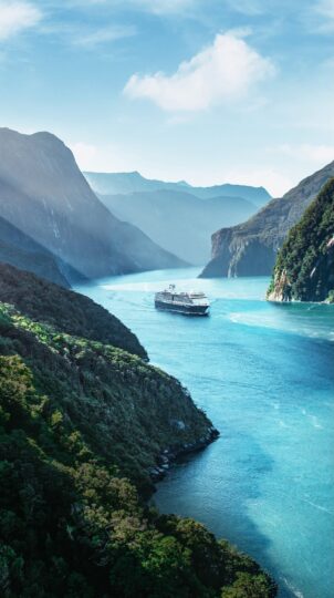 Cruise ship in scenic mountain fjord