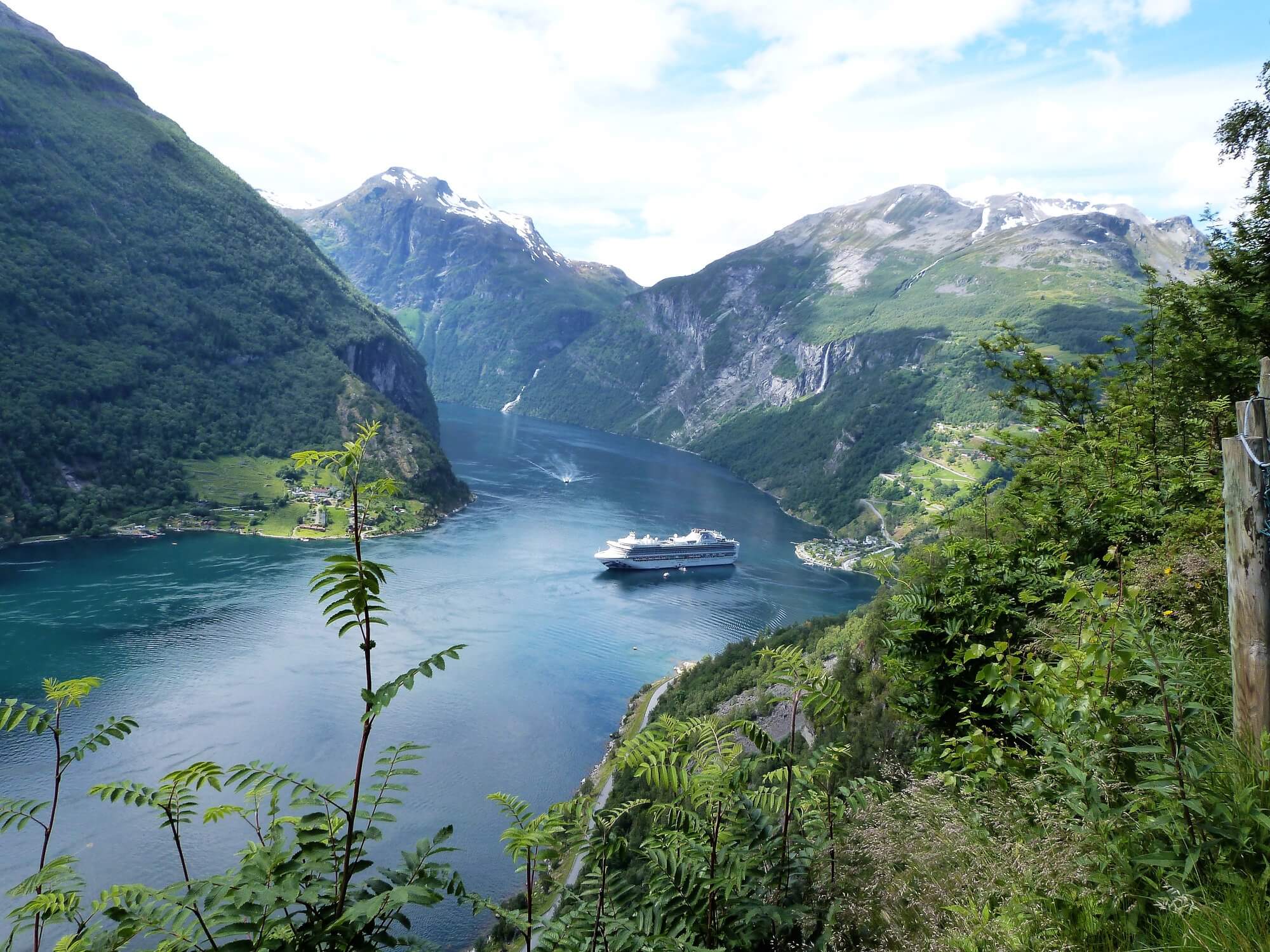 Cruise ship in scenic mountain fjord